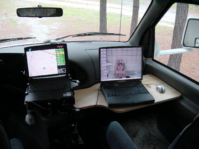 A picture of both laptops set up in the front of the RV.