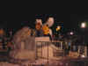 A picture of the ice sculpters finishing up their sculptures at night.